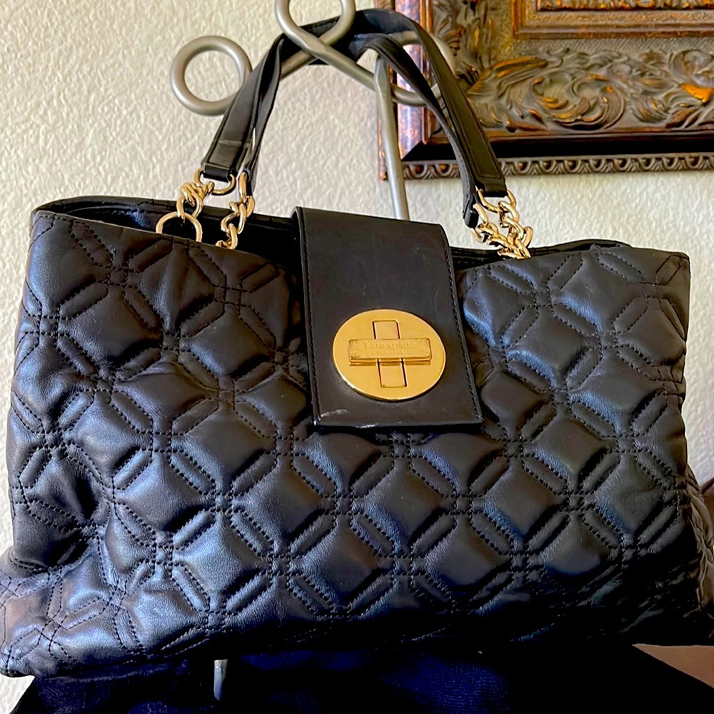 Kate Spade black quilted smooth leather with gold chain and lock.